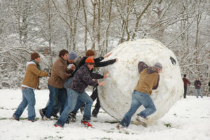 Group of people pushing a giant snowball 
"Giant Snowball" by Kamyar Adl is licensed under CC BY 2.0