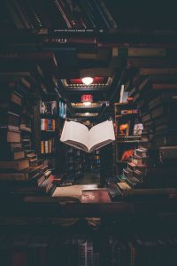 image of floating open book in a circle of other books