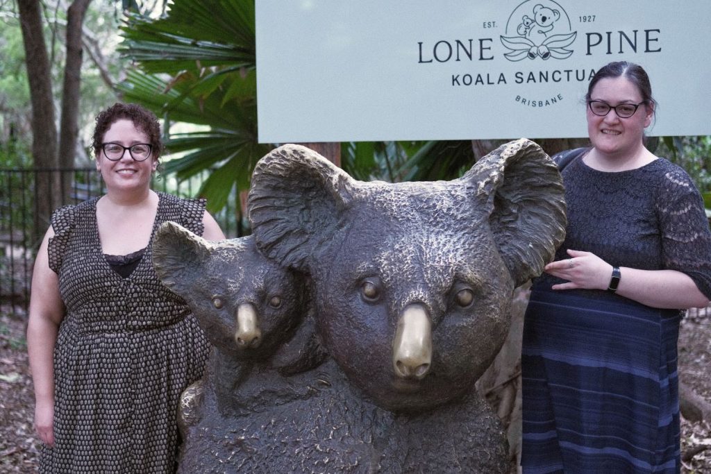 Heather Blicher and Liz Yata pose next to a large koala statue at the Lone Pine Koala Sanctuary in Brisbane, Australia