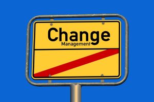A yellow sign that says "Change Management" on a blue background